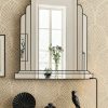 The Ritz Art Deco Wall Mirror is a sophisticated statement piece, exclusively designed and handcrafted in our Norfolk workshop by Mirror Mania. This elegant mirror features a large central panel framed by two gracefully curved mirror sections, all mounted on angled mirror strips to create a stunning three-dimensional effect. Finished with a black trim as standard – with options for gold or silver trim – the Ritz mirror captures the timeless glamour of classic Art Deco design.