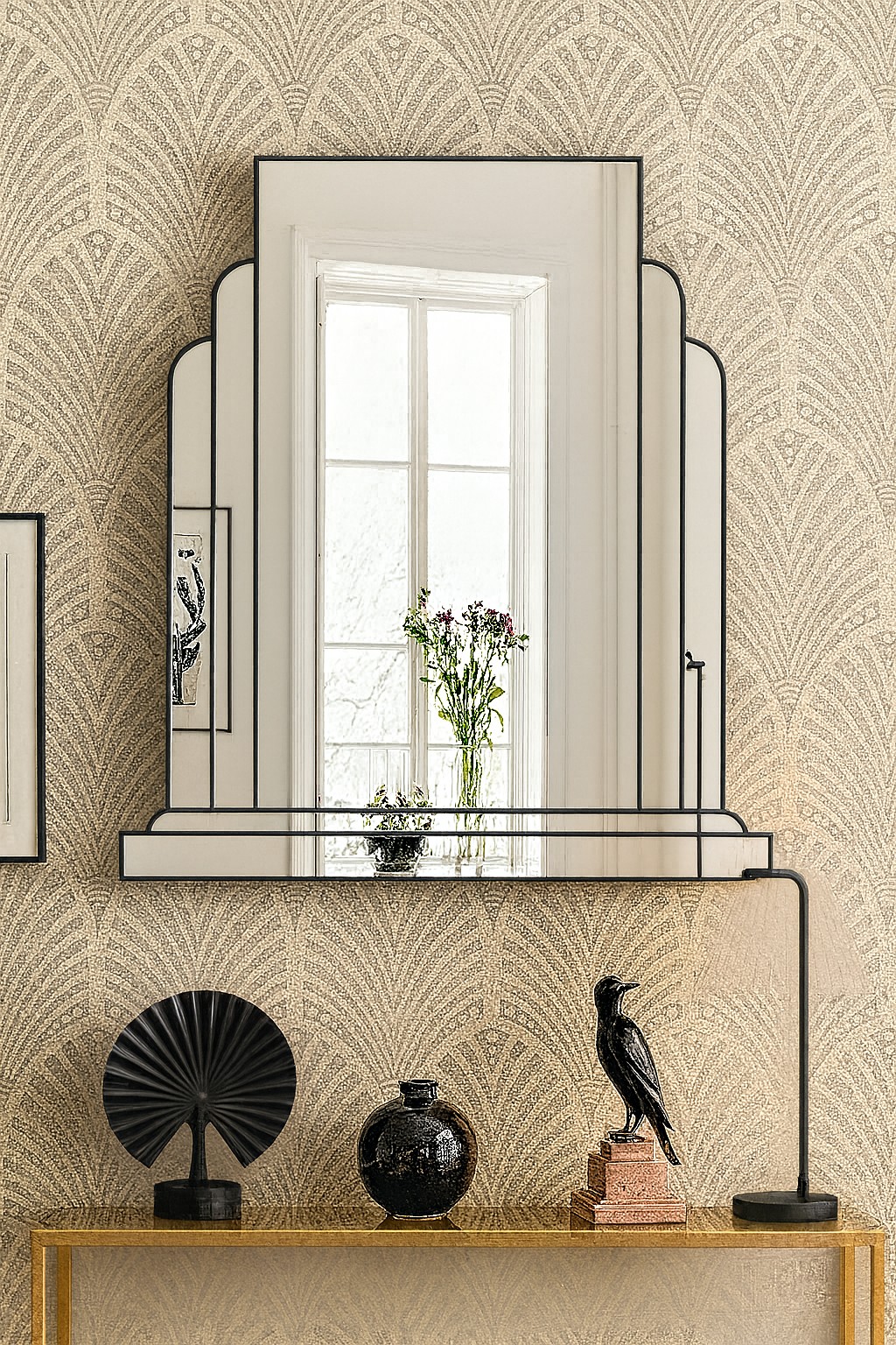The Ritz Art Deco Wall Mirror is a sophisticated statement piece, exclusively designed and handcrafted in our Norfolk workshop by Mirror Mania. This elegant mirror features a large central panel framed by two gracefully curved mirror sections, all mounted on angled mirror strips to create a stunning three-dimensional effect. Finished with a black trim as standard – with options for gold or silver trim – the Ritz mirror captures the timeless glamour of classic Art Deco design.