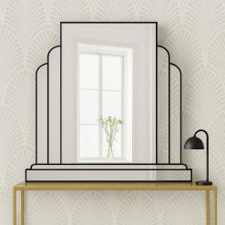 The Ritz Art Deco Wall Mirror is a sophisticated statement piece, exclusively designed and handcrafted in our Norfolk workshop by Mirror Mania. This elegant mirror features a large central panel framed by two gracefully curved mirror sections, all mounted on angled mirror strips to create a stunning three-dimensional effect. Finished with a black trim as standard – with options for gold or silver trim – the Ritz mirror captures the timeless glamour of classic Art Deco design.