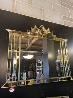 The Hobart Mirror is a stunning Art Deco over-mantle wall mirror, exclusively designed and handcrafted by British mirror artist Phillip Orr in our Norfolk workshop. This luxurious mirror features a bold central panel surrounded by angled mirrored sections and finished with a striking fan-shaped crown – a classic Art Deco statement for elegant interiors.