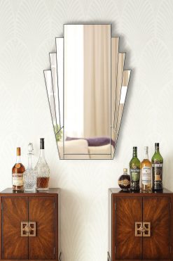 The Minerva Original Handcrafted Fan Art Deco Wall Mirror with a Silver Trim is the perfect addition to an art deco enthusiasts' room. With an elegant fan shape, the mirror features clear mirror fans, framing a central clear mirror, with all sections finished with a silver trim. As this mirror will be handmade to order, you can have it made to a size to suit your home or, alternatively add colour to it to suit your room.