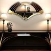 Elise Deco Nouveau Wall Mirror: Handcrafted in Norfolk, England, by mirror artist Phillip Orr. Gold and black glass frame surrounds a central clear mirror. Intricate Art Deco design inspired by 1920s headress, offering a unique blend of elegance and innovation