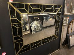 The Atticus Handcrafted Art Deco Glam Wall Mirror has been handmade in our Norfolk workshop by our in house designer – Phillip Orr. This attractive, handmade art deco mirror will add a touch of glamour to any room. Featuring a jet black glass border, with a geometric design in gold, and a central plain mirror.