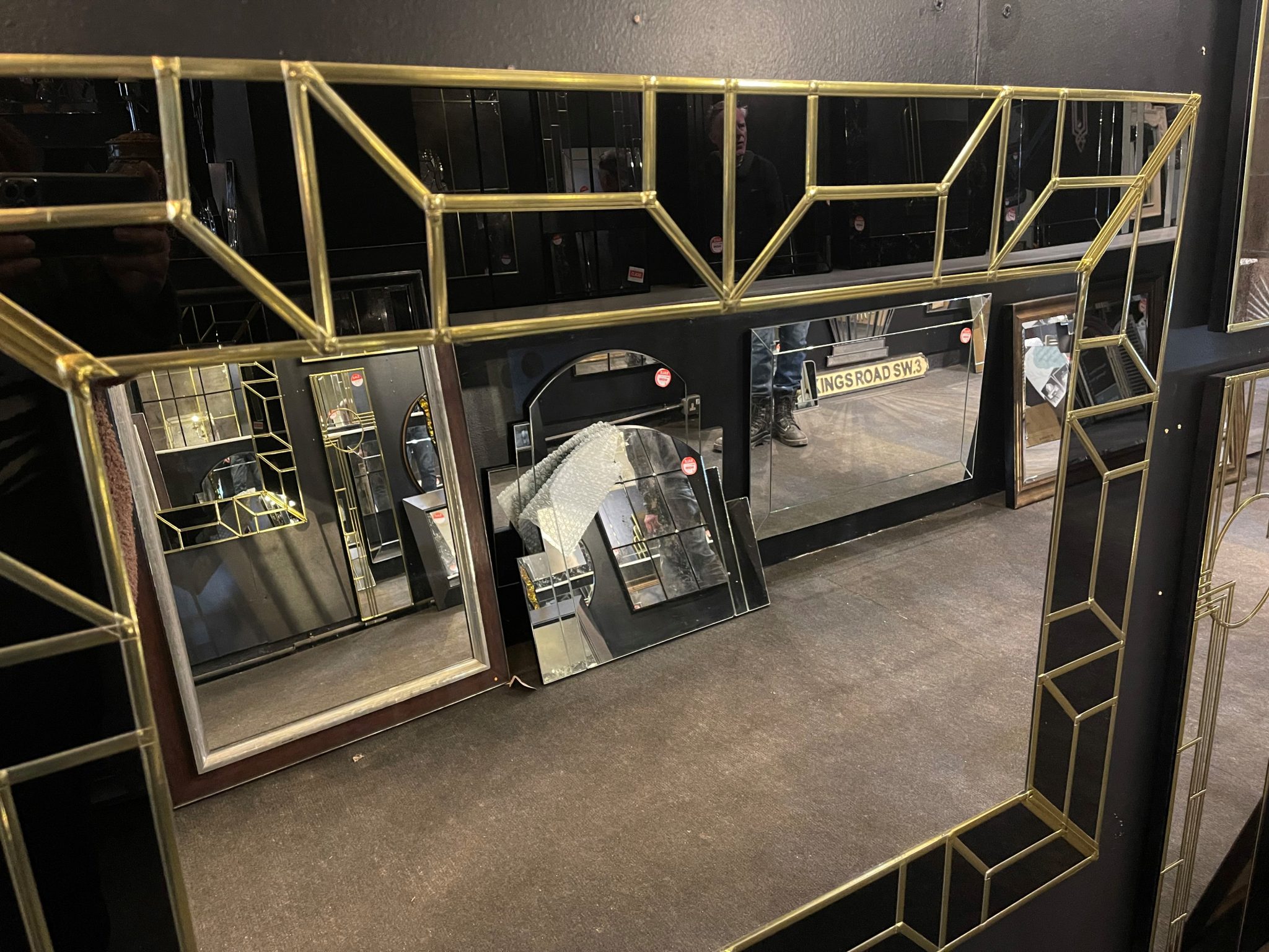 The Atticus Handcrafted Art Deco Glam Wall Mirror has been handmade in our Norfolk workshop by our in house designer – Phillip Orr. This attractive, handmade art deco mirror will add a touch of glamour to any room. Featuring a jet black glass border, with a geometric design in gold, and a central plain mirror.